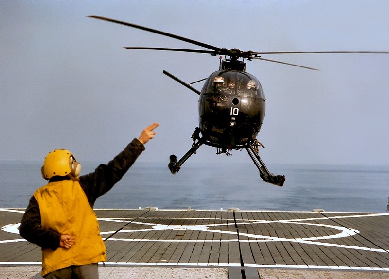 H-500 taking off from a flight deck