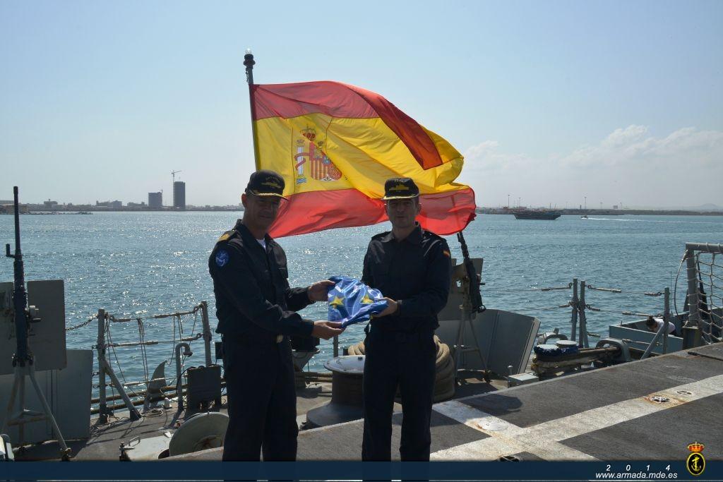 The frigate’s CO hands the EUNAVFOR ensign to the OPV’s Commanding Officer