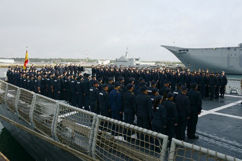 The crew in formation on the ship’s flight deck