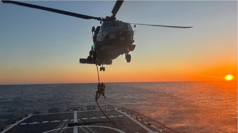 An SO element fast-roping from an SH-60B.